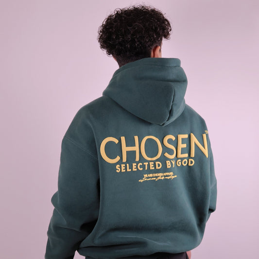 Close-up of ‘We Are His Masterpiece’ script on forest green hoodie by We Are Chosen Apparel