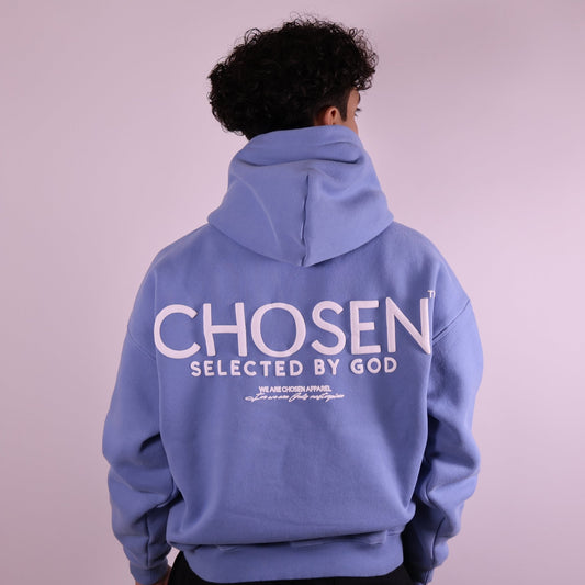 Close-up of ‘We Are His Masterpiece’ script on medium blue hoodie by We Are Chosen Apparel