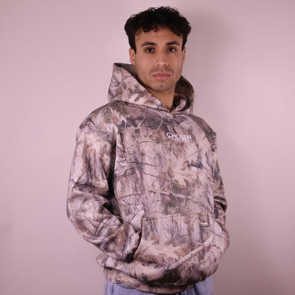 Man wearing a camouflage hoodie with Chosen branding on a plain background