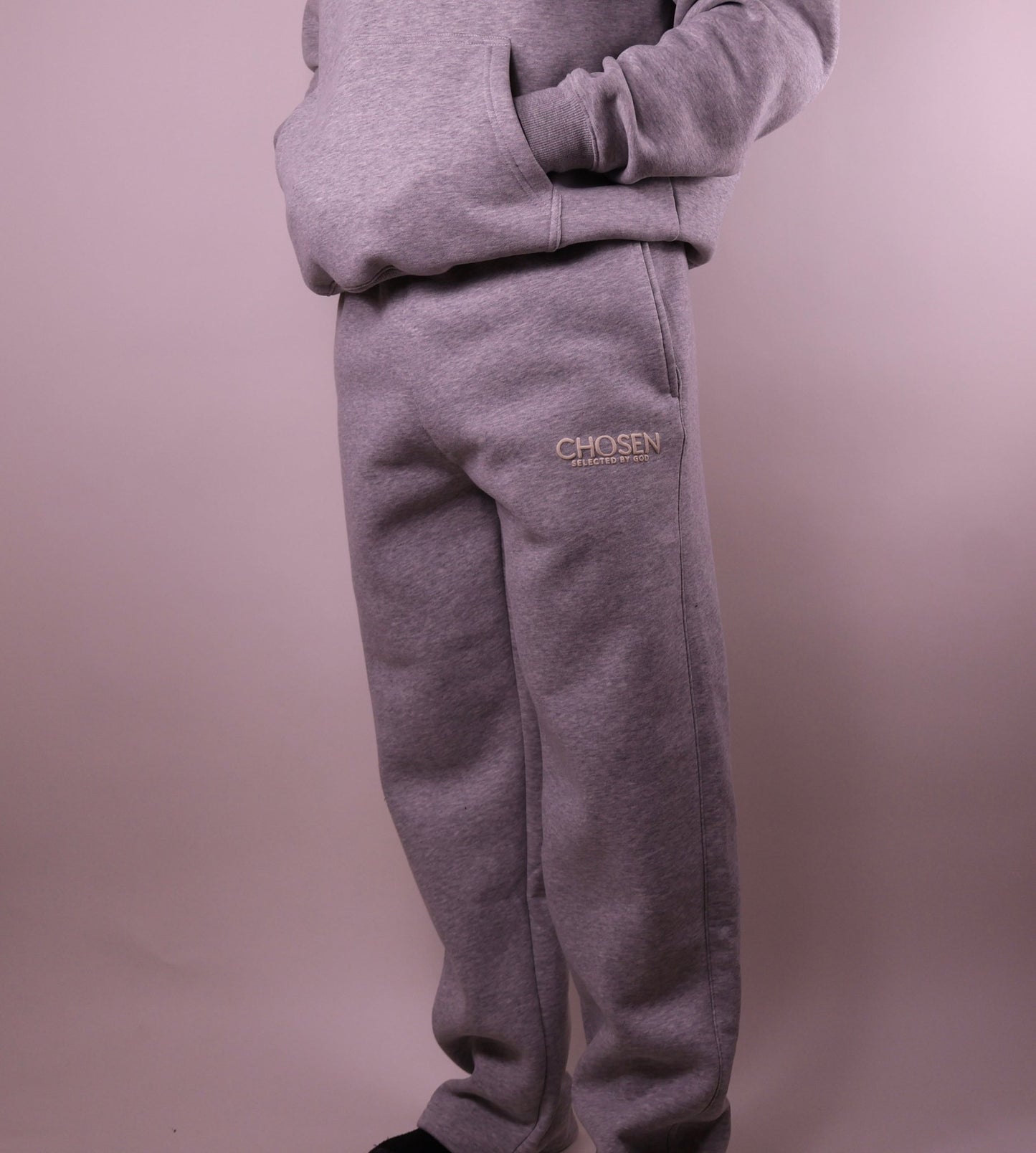 Gray sweatpants with Chosen logo on a plain background