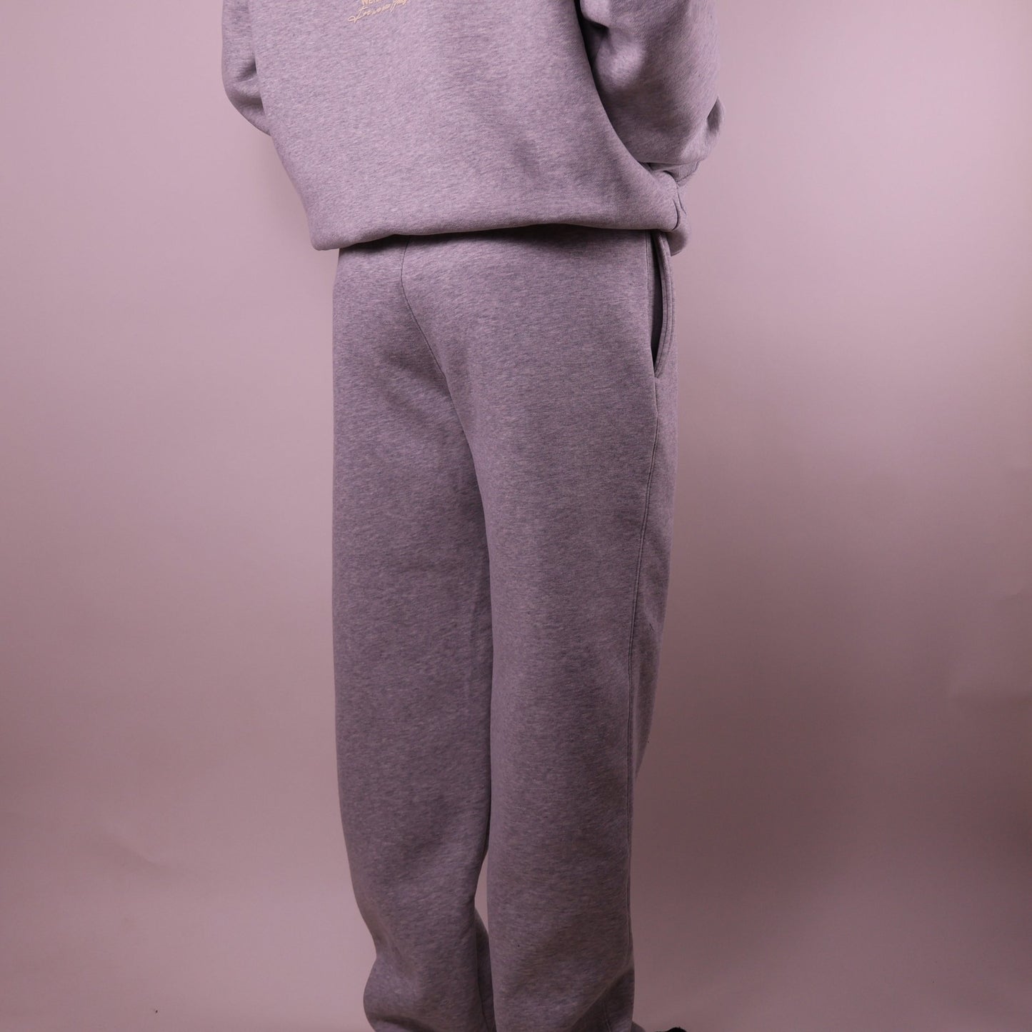 Gray sweatshirt and pants set on a plain background