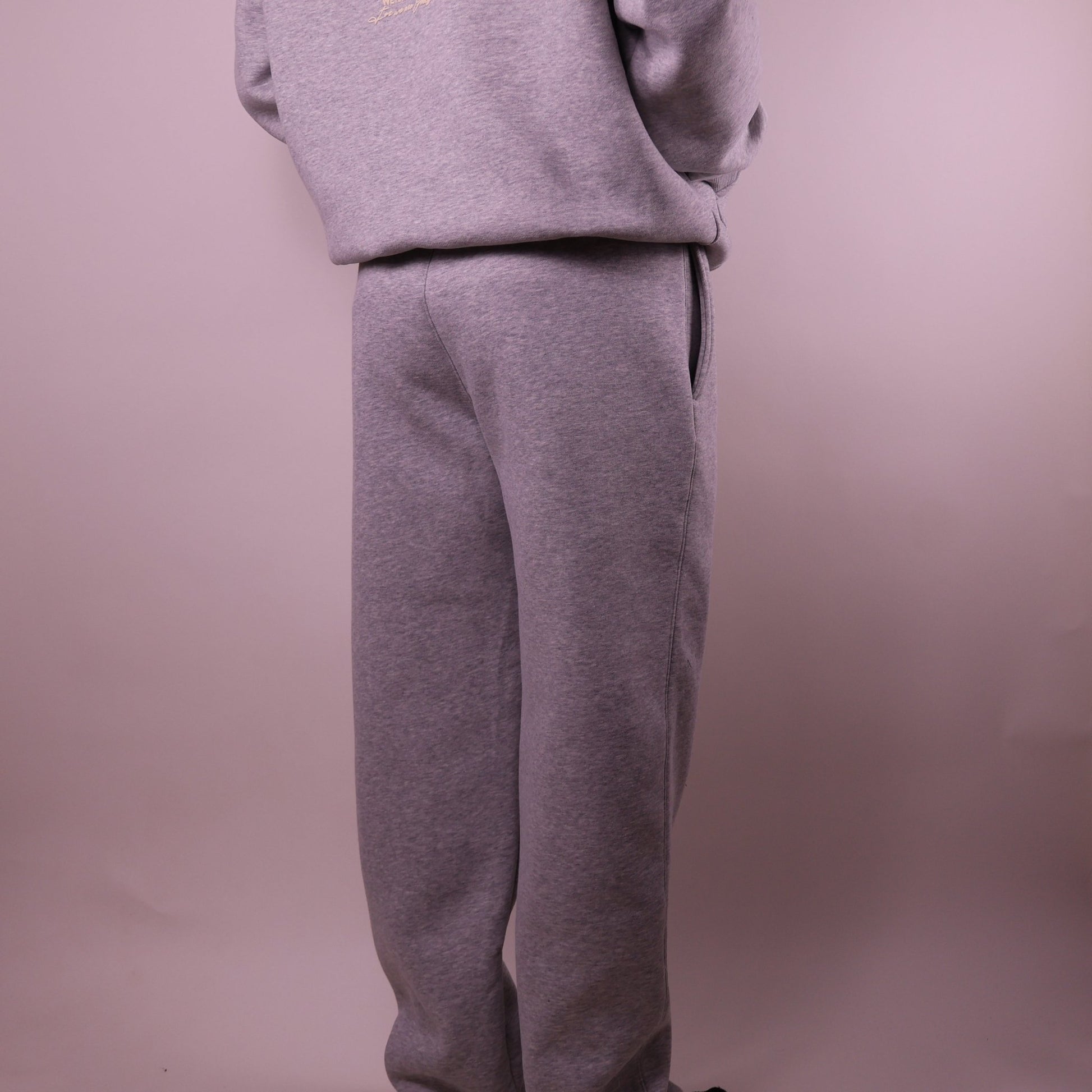 Gray sweatshirt and pants set on a plain background