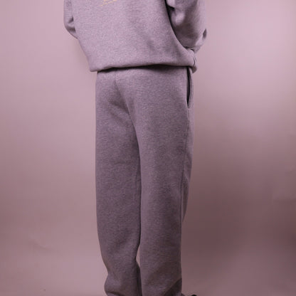 Gray sweatshirt and pants set on a plain background