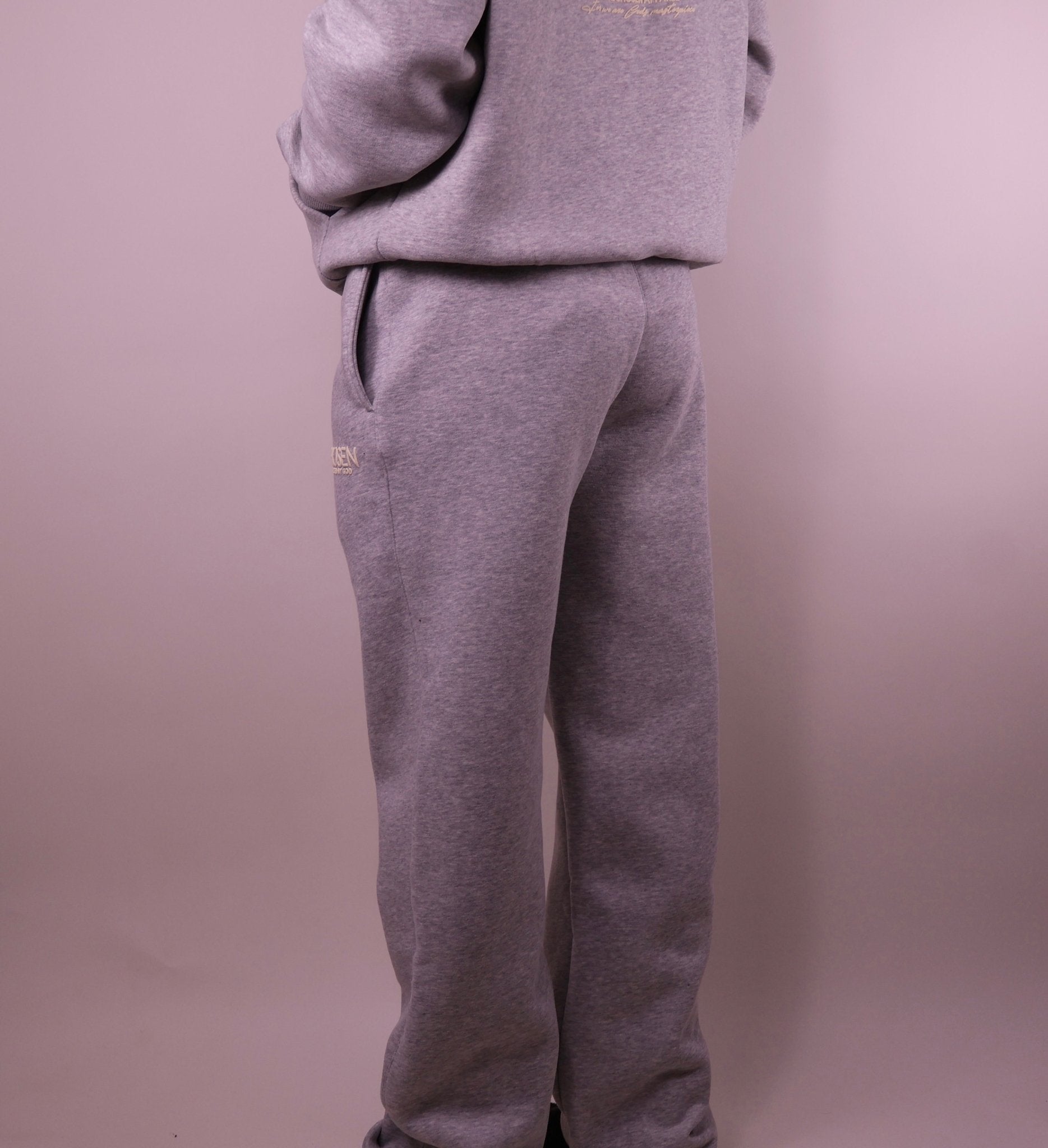 Gray sweatpants with a brand logo on a plain background