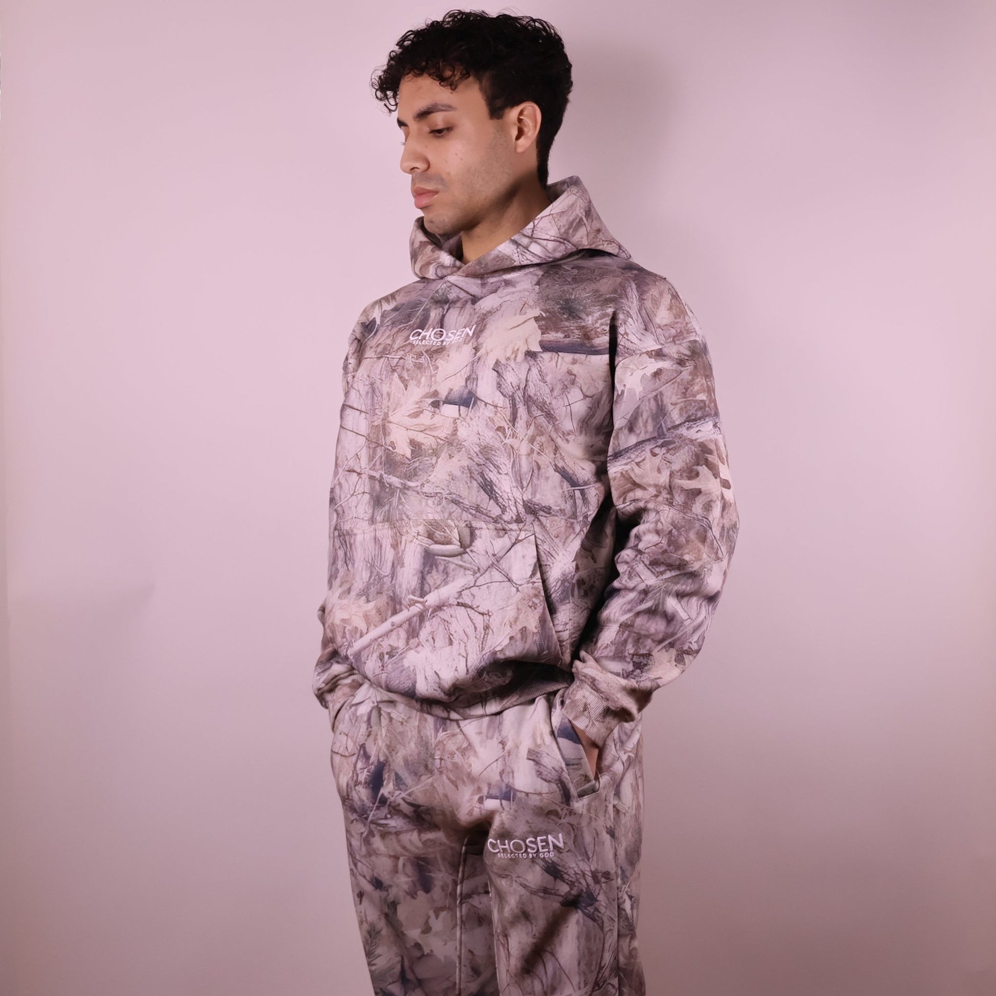 Person wearing a camouflage outfit with a plain background