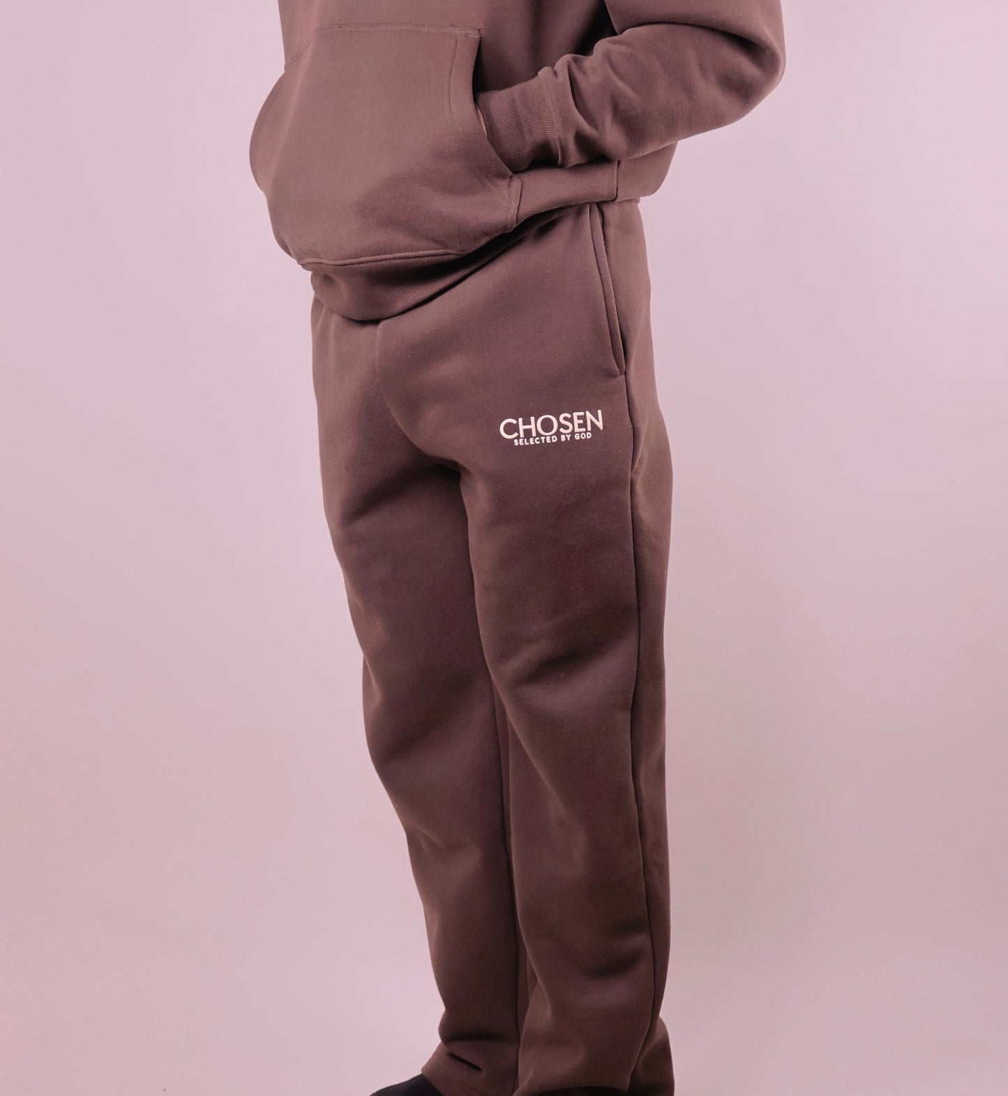 Brown tracksuit with Chosen logo on a light purple background