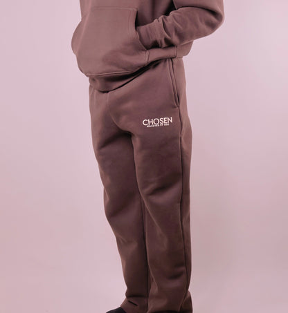 Brown tracksuit with Chosen logo on a light purple background